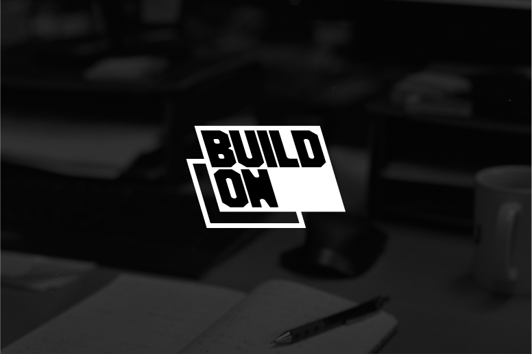 Build On logo over a black-and-white desk scene